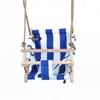 A baby swing seat with blue and white stripes, suspended by ropes against a white background. Produktbild-Vorschau
