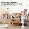 A woman is holding a baby on a couch, with a robot vacuum cleaner in the foreground and shelves in the background. Produktbild-Vorschau