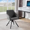A dark gray velvet chair with black metal legs is placed in a room with a large window overlooking a suburban house and lawn. A white desk with a computer is visible in the background. Produktbild-Vorschau