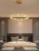 A modern bedroom with a large bed and a crystal chandelier. Anteprima dell’immagine prodotto