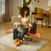A woman is working on her laptop while sitting in an orange office chair. A small dog is sitting on the chair next to her. Produktbild-Vorschau