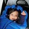 A baby wrapped in a blue sleeping bag in a stroller. Produktbild-Vorschau