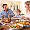 A family enjoying a meal together at a table. Produktbild-Vorschau