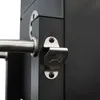 A close-up shot of a bottle opener attached to a black grill. Podgląd zdjęcia produktu