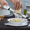 Hands grating cheese over a bowl of food. Anteprima dell’immagine prodotto