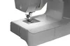 A close-up view of the needle and presser foot area of a white sewing machine. Produktbild-Vorschau