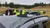 Skis mounted on a car roof rack in an outdoor setting. Náhled obrázku produktu