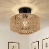 A close-up shot of a ceiling light fixture with a woven shade, mounted on a white ceiling. Produktbild-Vorschau