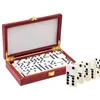 A set of dominoes in a red wooden box, with some dominoes laid out in front of the box. Náhľad obrázku produktu