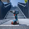 A Bosch cordless impact wrench is placed on a metal staircase outdoors. Voir les images du produit
