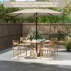 An outdoor patio scene with a round table, chairs, and a large umbrella. Podgląd zdjęcia produktu