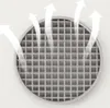 A close-up view of a circular metallic grid with white arrows indicating airflow moving upwards and outwards. Náhled obrázku produktu