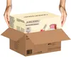 Hands placing a toy wooden toaster box into a cardboard shipping box. Anteprima dell’immagine prodotto