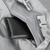 A close-up view of a black wallet inside a gray zippered pocket of a bag. Produktbild-Vorschau