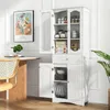 A white cabinet with glass doors and shelves filled with kitchenware and food items, placed in a dining room setting next to a table and chair. Podgląd zdjęcia produktu