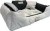 A light gray dog bed with black accents and pillows, presented on a white background. Voir les images du produit