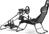 A racing simulator cockpit with a seat, steering wheel, and pedals, shown against a white background. Podgląd zdjęcia produktu