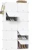 A white modular shoe storage organizer filled with various shoes and boots, with a handbag hanging on the side. Produktbild-Vorschau