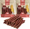 Two bags of dog treats with a pile of treats in front. Produktbild-Vorschau