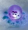 A glowing purple octopus toy floats in a bubble bath. Produktbild-Vorschau