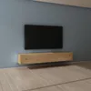 A modern living room with a wall-mounted television and a floating media console. Produktbild-Vorschau