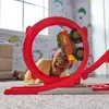 A young boy is playing with a toy car track, with the car going through a loop. Náhľad obrázku produktu