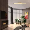A modern living room with a dining area, featuring a fireplace, TV, and artwork. Produktbild-Vorschau