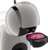 Close-up of a Nescafé Dolce Gusto coffee machine with a coffee pod inserted. Náhled obrázku produktu