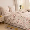 A neatly made bed with floral patterned bedding. Náhľad obrázku produktu