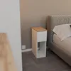 A bedside table next to a bed in a bedroom. Náhled obrázku produktu
