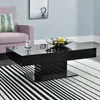 A modern living room scene featuring a black high-gloss coffee table. Produktbild-Vorschau