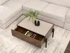 A coffee table with an open drawer, placed on a rug next to a sofa. Náhled obrázku produktu