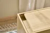 A close-up view of a wooden cabinet with a sliding drawer or shelf. Podgląd zdjęcia produktu