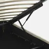A close-up view of the internal mechanism of a bed frame, showing the gas lift struts and wooden slats. Produktbild-Vorschau