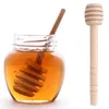 A jar of honey with a honey dipper and a separate honey dipper. Podgląd zdjęcia produktu