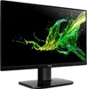 A computer monitor with a black background and a colorful splash of green and yellow liquid on the screen. Produktbild-Vorschau