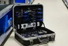 An open tool case filled with various tools, placed on a floor next to shelving units. Produktbild-Vorschau
