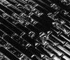 A close-up, diagonal view of black mosaic tiles with reflective elements. Anteprima dell’immagine prodotto
