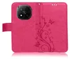 A pink flip phone case with a floral embossed design. Produktbild-Vorschau