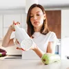 A woman in a kitchen is holding a white pasta maker. Produktbild-Vorschau