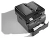 A black Brother MFC-L2860DW 4-in-1 laser multifunction printer is shown from a high angle, with the paper output tray extended and a piece of paper partially visible. Produktbild-Vorschau