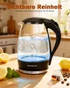 A glass electric kettle filled with boiling water, placed on a wooden surface with lemons and tea bags. Produktbild-Vorschau