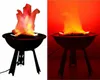 A split image showing a simulated flame light on a grill stand. The left side has a white background, and the right side has a red background. Produktbild-Vorschau