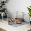 A dog is lying in a playpen indoors. Anteprima dell’immagine prodotto