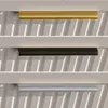 Three different colored handles are displayed horizontally against a white background with vertical lines. Produktbild-Vorschau