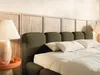 A bedroom scene with a bed and bedside table. Produktbild-Vorschau