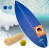 A blue balance board with accessories on a background of ocean waves. Produktbild-Vorschau