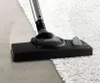 A vacuum cleaner head is shown cleaning a white rug adjacent to a hard floor. Náhled obrázku produktu