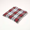A square seat cushion with a plaid pattern is shown on a white background. Náhled obrázku produktu