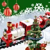 A festive toy train with Christmas decorations, including Santa Claus and a Christmas tree, on a snowy background. Náhľad obrázku produktu